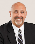 portrait of Kenneth Fiola in dark suit with white shirt and striped tie