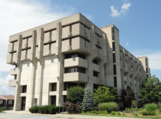 olsen hall at umass lowell - cement multi level structure with greenery of varying sizes in front