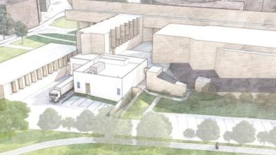 Drawing of multi sections and heights building with loading dock and truck parked at the loading dock